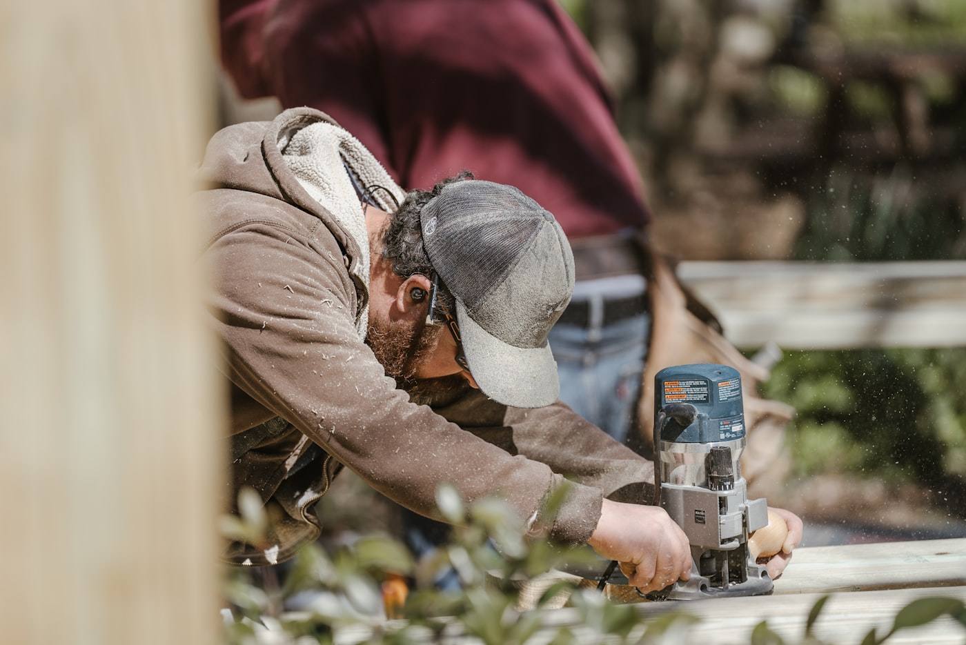 Carpenter repairing rotted wood framing during a professional dry rot repair