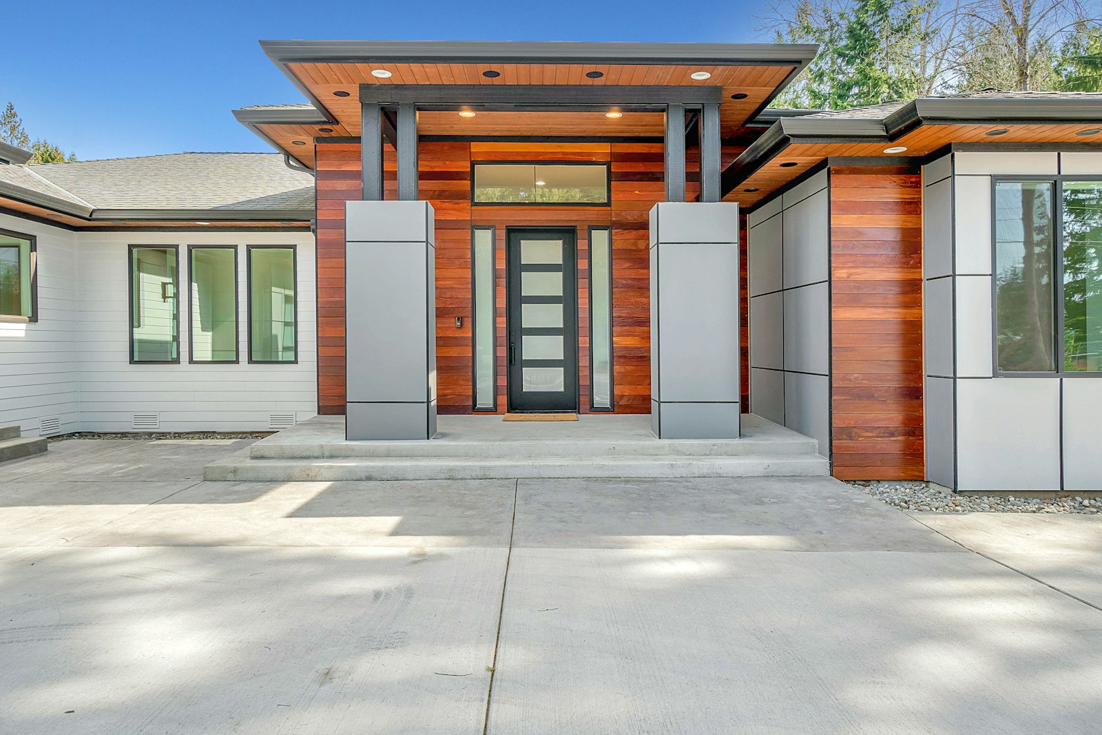 Modern Seattle-area home with white fiber cement lap siding and wood accent panels