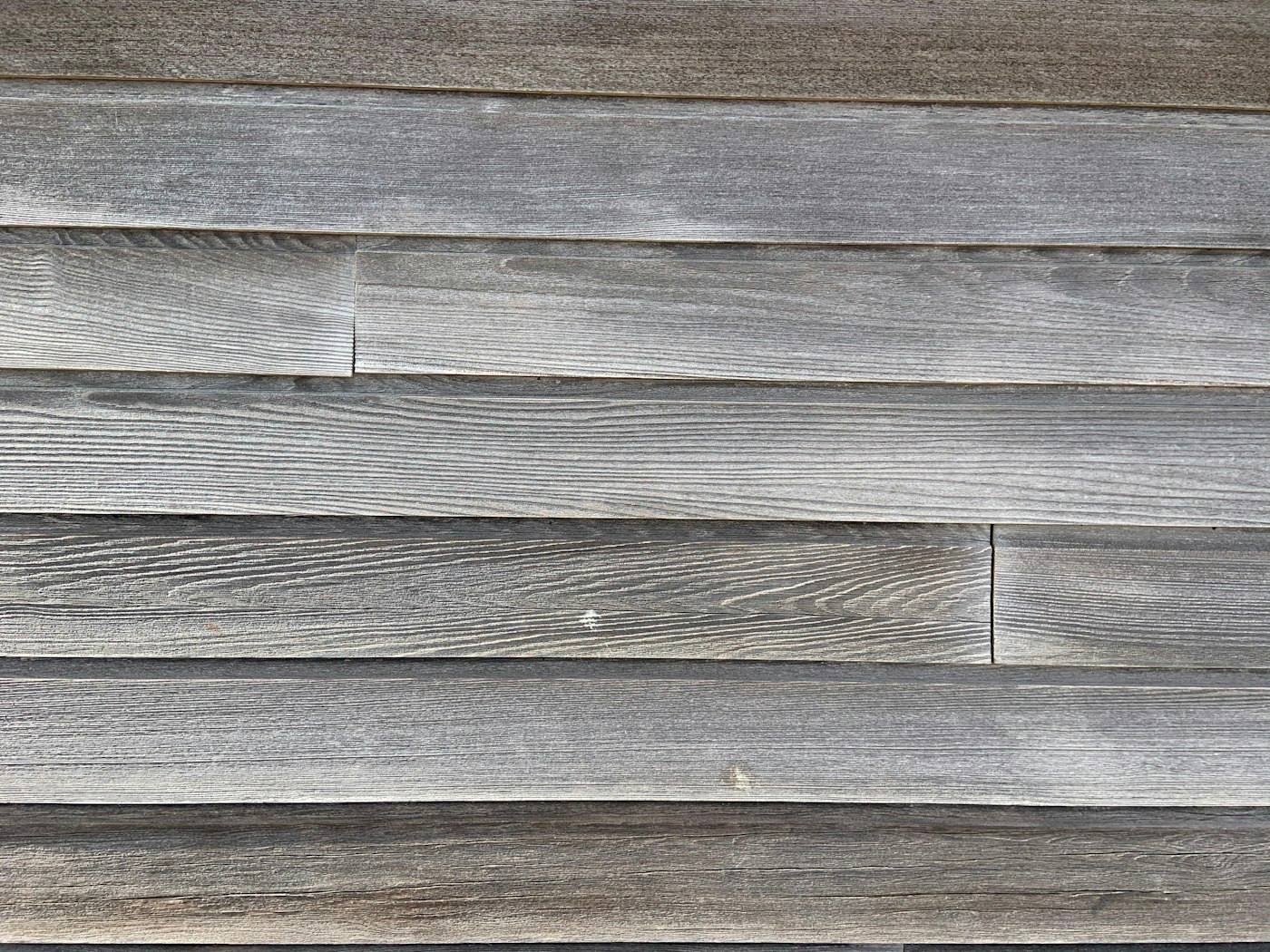 Weathered wood siding showing the kind of wear that leads to dry rot without regular maintenance
